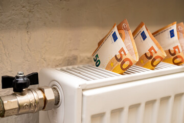 Close-Up Of White Radiator And 50 Euro Banknotes. Concept Of Expensive Heating And Electricity.