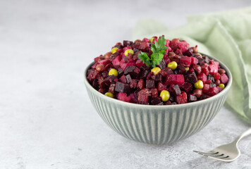 Traditional Russian salad - vinaigrette on a gray background, copy space. Beetroot Salad. Vegetarian food.