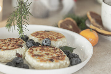 Syrniki.Fried quark pancake. Cottage cheese pancakes in winter time. Homemade traditional Ukrainian dish. High Protein breakfast