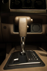 Automatic gear stick inside modern brown leather car. Luxury and expensive concept.