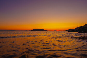 Orange sunset over sea in late evening