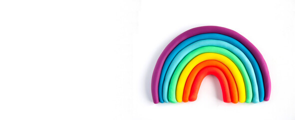 Banner of a colorful rainbow of plasticine on white background. Made from plasticine. Isolate