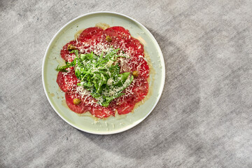 Marbled beef carpaccio with arugula, capers and parmesan cheese