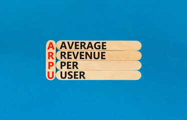 ARPU average revenue per user symbol. Concept words ARPU average revenue per user on wooden stick on beautiful blue background. Business ARPU average revenue per user concept. Copy space.