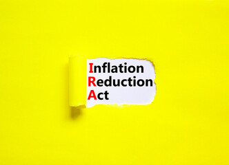 IRA inflation reduction act symbol. Concept words IRA inflation reduction act on white paper on a beautiful yellow background. Business IRA inflation reduction act concept. Copy space.