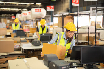 Teamwork of Asian workers working in large warehouse store industry.Rack of stock storage. Interior of cargo in ecommerce and logistic concept. Depot. People lifestyle. Shipment service for container