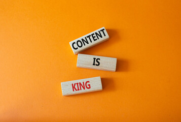 Content is king symbol. Concept words Content is king on wooden blocks. Beautiful orange background. Business and Content is king concept. Copy space.