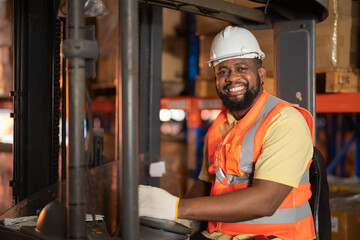Portrait of black man worker working in large warehouse retail store industry factory. Rack of...