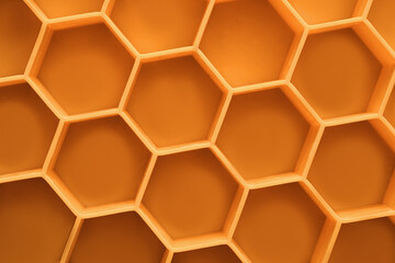 Silicone mold for ice orange color close-up macro. Top view of hexagons. Beautiful background concept. Beautiful photo of a silicone form with space for text