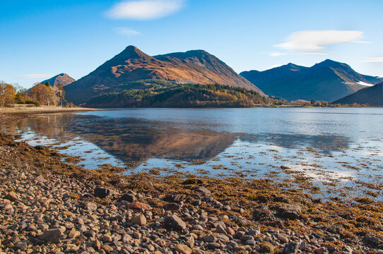 The Pap of Glencoe reflected in the still waters of Loch Leven on crisp autumn morning