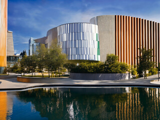 Obraz na płótnie Canvas Modern futuristic architecture city view with water in foreground, generative AI