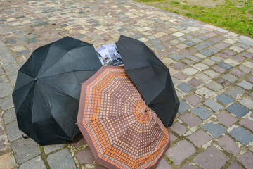 umbrellas lie outside on a stone walkway