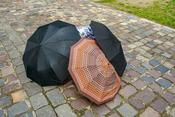 umbrellas lie outside on a stone walkway