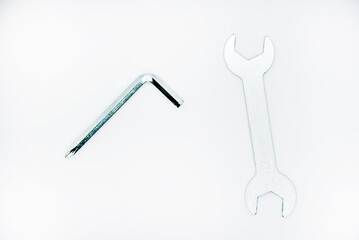 Two iron construction keys on a white background. A horn wrench and a screwdriver.