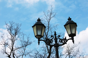 Fototapeta na wymiar Street lamps on Metal pole against the background of cloudy blue sky by Afternoon sun. Selective focus.