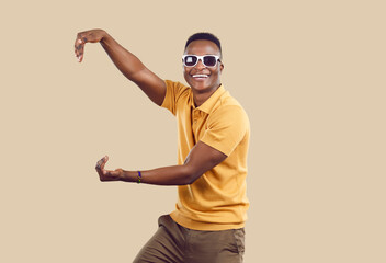 Funny dark-skinned man with both hands pretends to hold an object or thing showing off size....