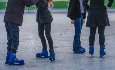 People Ice skating on outdoor rink in Hyde park London winter wonderland