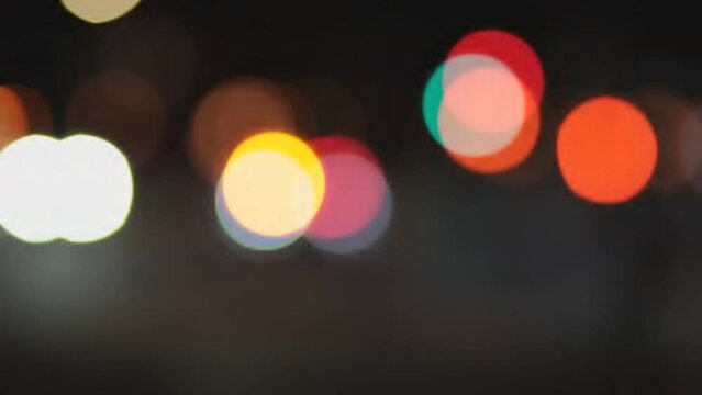 Blurred bokeh of fast moving city lights traffic in whites, reds and yellows defocused
