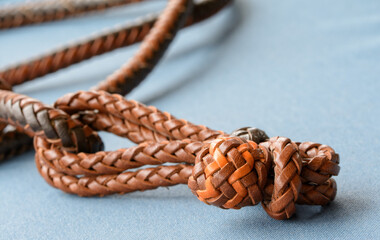 Two colored leather button knot on handbraided leather reins