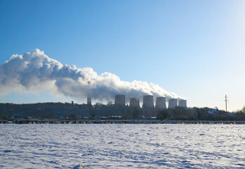 Power station cooling towers producing steam in winter
