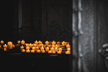 Prayer candles burn just inside the vestibule of Margarethenkapelle, Salzburg, Austria 