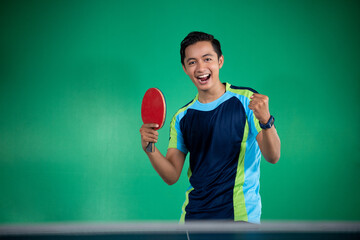 Asian male players are excited by screaming when they win a ping pong match © Odua Images