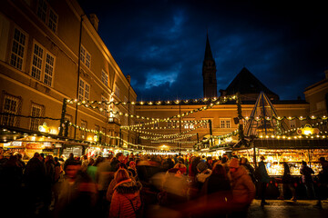 Busy Domplatz Christmas Market at night in Salzburg, Austria - Off center