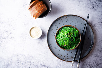 Green seaweed spicy salad with sesame seeds in a bowl © nata_vkusidey