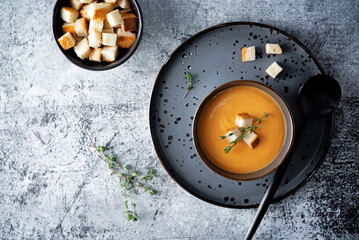 Sweet potato soup with croutons and thyme leaves