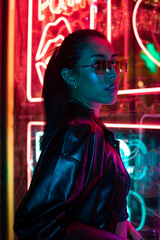 Cinematic night portrait of girl and neon lights
