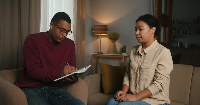 Professional therapist listens to woman sharing problems