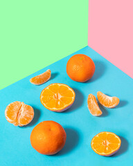 Fresh tangerines on pastel light colorful background. Minimalistic fruit concept. Creative summer nature composition.