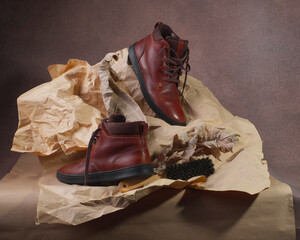 A pair of kraft-wrapped tie-dyed batins with dried leaves and crumpled paper