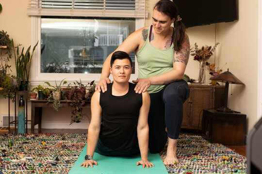 Asian American trans man doing yoga.
