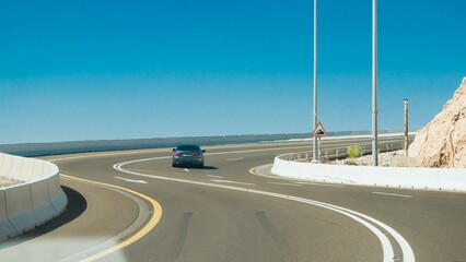 beautiful curved road view with blue sky and BMW