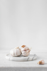Obraz na płótnie Canvas Garlic bulbs on a marble tray, garlic, raw garlic, Allium sativum