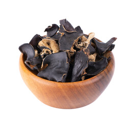Dry black fungus in wooden bowl, isolated on white background. Chinese black mushroom or tree black muer mushroom. Auricularia polytricha.