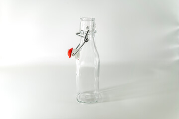 Empty glass bottle with hanging stopper