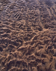 the sun bounces off of a sandy shoreline