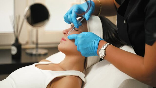 Latin girl having mesotherapy procedure at the spa, cosmetic procedure concept. High quality 4k footage