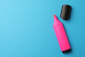 Bright pink marker on light blue background, flat lay. Space for text