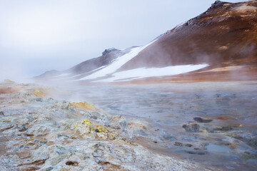 Boiling Mud Pots in the Iceland Volcanically Active Zone and Smoking Cracks in the Ground Around. Location: Geothermal Area Hverir, Myvatn Region, North Part of Iceland, Europe