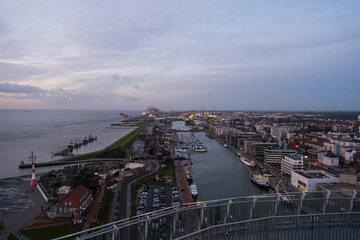 Sunset in Bremerhaven with houses and ships and the (bremer Schiffahrts-Museum), Klimahaus and the coast line of Bremerhaven (technik museum) taken from 90 m high bulding, Monochrom, sepia, panorama 