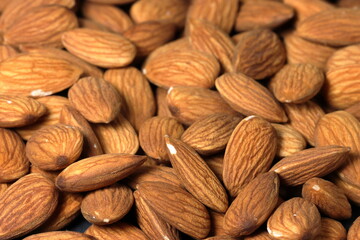 Almond on back background. Macro shot. Group of almond nuts on back background