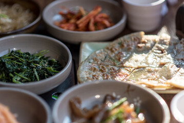 Fototapeta na wymiar Assortment of Korean food in a Korean traditional restaurant. Buckwheat pancakes