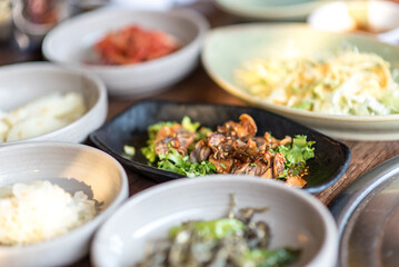 Assortment of Korean food in a Korean traditional restaurant. Seashell with spicy saurce and vegetables.