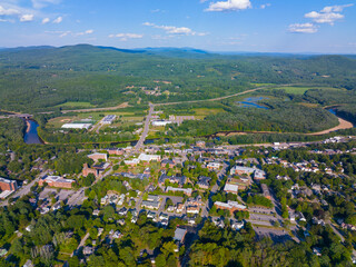 Plymouth State University and Pemigewasset River aerial view with White Mountain National Forest at the background in summer in historic town center of Plymouth, New Hampshire NH, USA.  - obrazy, fototapety, plakaty