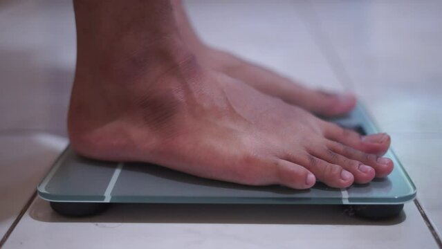 Man Feet Standing Weighing Scales, Checking BMI Weight Loss. Barefoot Measuring Body Fat Overweight