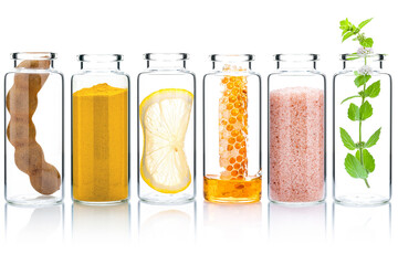 The glass bottle of homemade skin care and body scrubs with natural ingredients aloe vera ,himalayan salt ,peppermint ,rosemary ,turmeric and honey isolate on white background.
