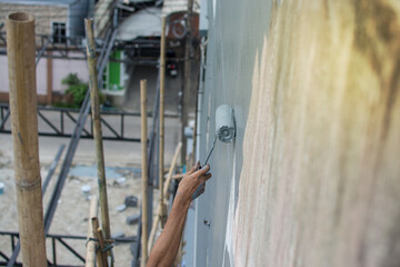 using paint roller for paint building wall